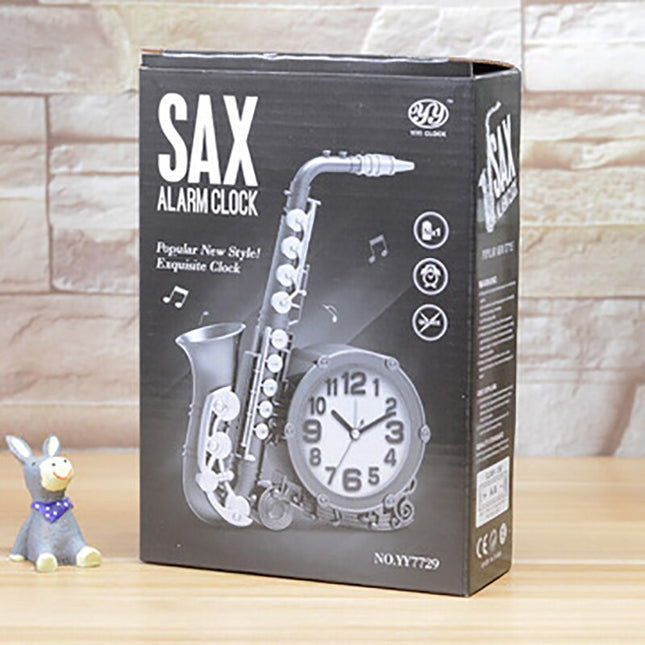 Bordsklocka i metall formad som saxofon